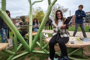 Emily Rabinowitz ’24 (ENG) charging her iPad connected to the STEAM Tree on the Student Union Mall