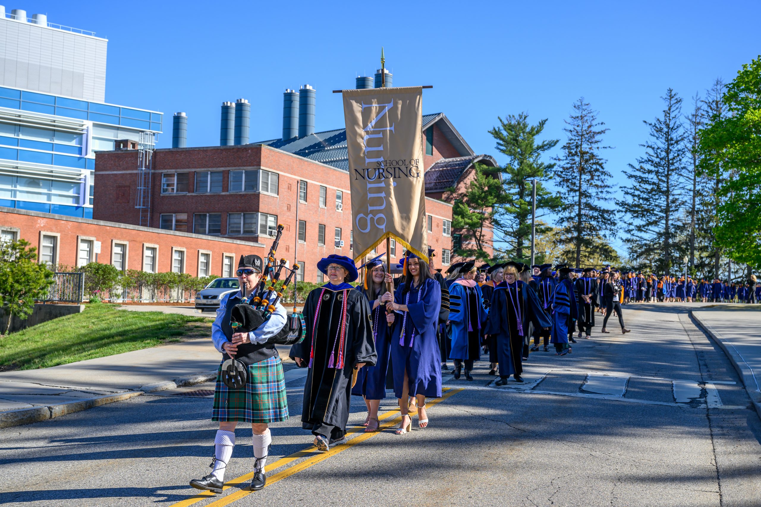A bagpiper leads the School of Nursing Commencement procession