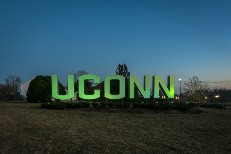 Entryway sign lit up green for St. Patricks Day and for Sustainability. March 16, 2022.