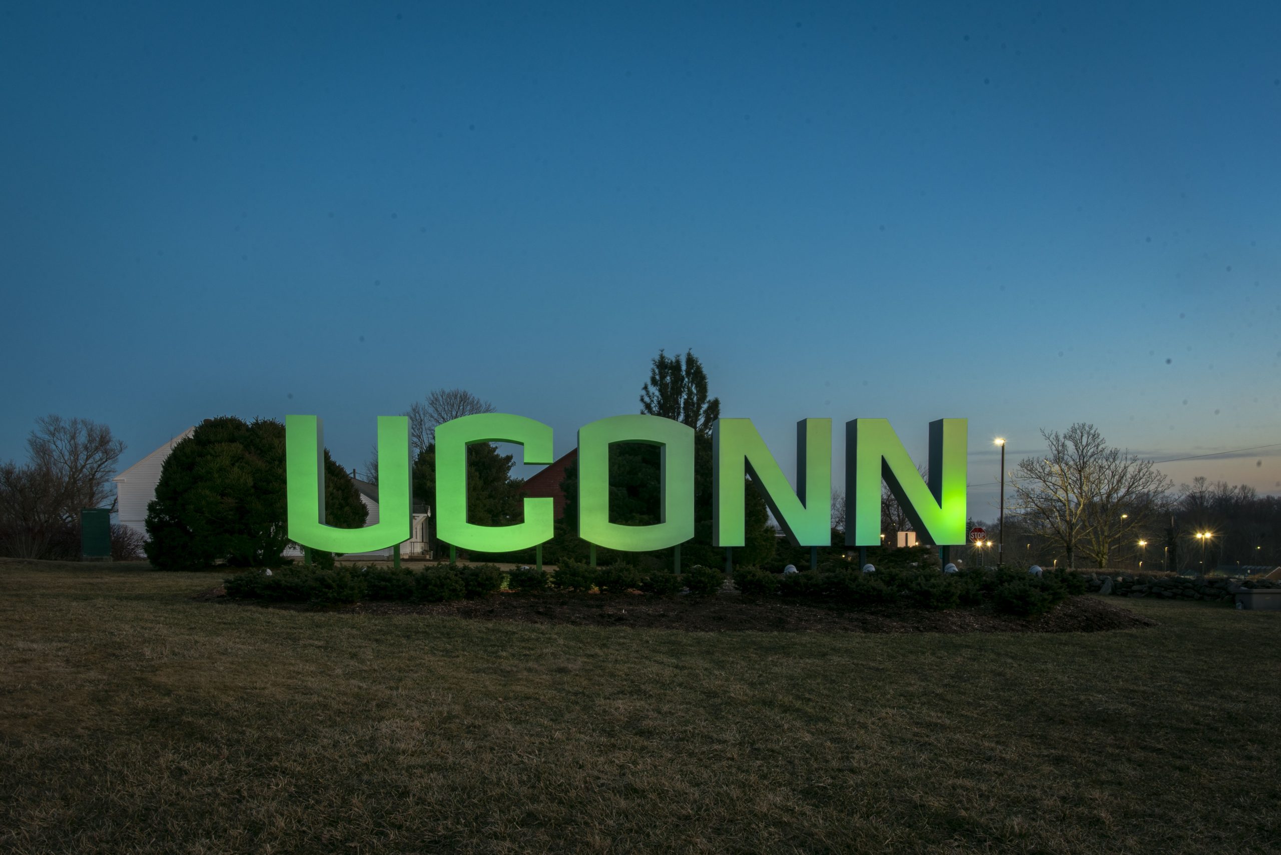 Entryway sign lit up green for St. Patricks Day and for Sustainability. March 16, 2022.
