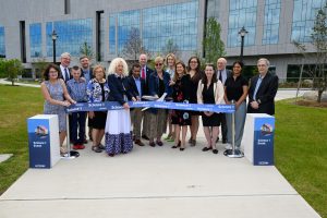 (l-r) Rep. Kathy Kennedy; Rep. Tim Ackert and his grandson, Jameson; Mansfield Town Manager Ryan Aylesworth; Mansfield Mayor Toni Moran; President Radenka Maric; Sen. MD Rahman; Rep. Gregg Haddad; Sen. Cathy Osten; Rep. Holly Cheeseman; Lt. Gov. Susan Bysiewicz; Sen. Mae Flexer; Provost Anne D'Alleva; Trustee Philip Rubin; Student Trustee Aanya Mehta; and Institute for Materials Science Director Steven Suib join together at the dedication of the Science One Research Center on June 15, 2023. (Peter Morenus/UConn Photo).