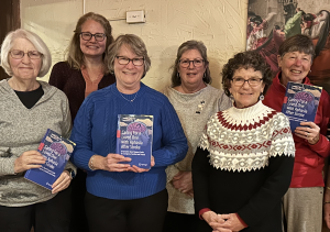 Five of the essayists who contributed their stories to "Caring For a Loved One with Aphasia After Stroke" stand with Jennifer Mozeiko, second from left, from UConn's Aphasia Rehab Lab. Mozeiko and essayist Deborah Yost, second from right, co-edited the book.