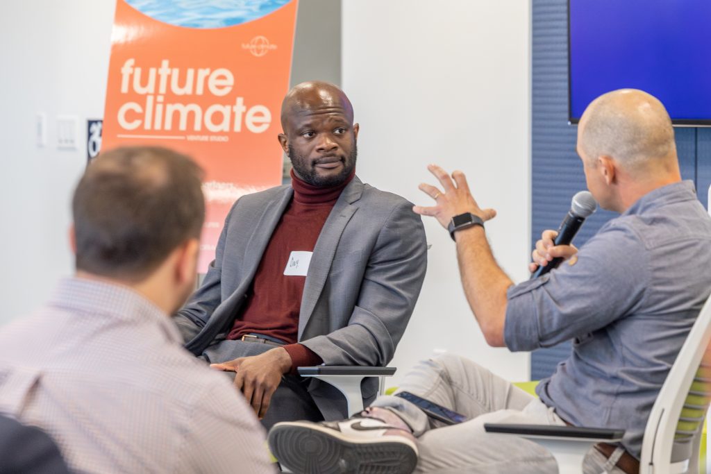 Onyeka Obiocha, left, executive director of CTNext, chats with Cody Simms of MCJ Collective during the Future Climate Venture Studio showcase in the Innovation Partnership Building on April 20, 2023.