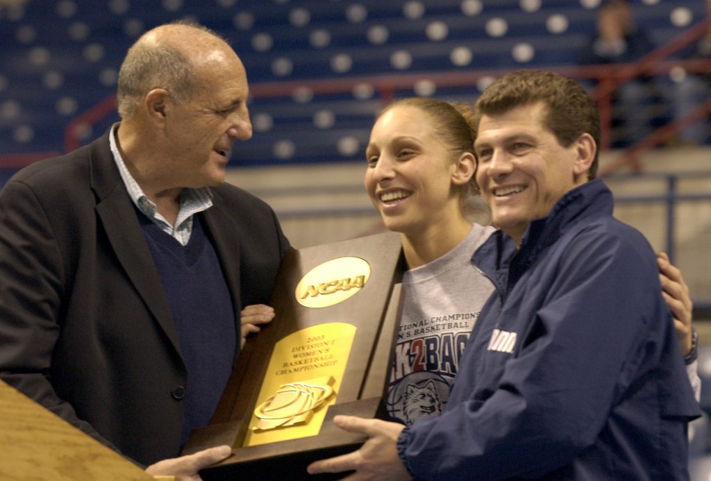 Lew Perkins celebrates the 2003 women's basketball national championship with Diana Taurasi and Geno Auriemma at Gampel Pavilion.