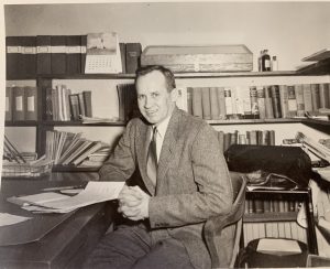 William Aho is pictured in his UConn office in April 1956, four years after he joined UConn as a professor of poultry sciences and UConn Extension agent. 
