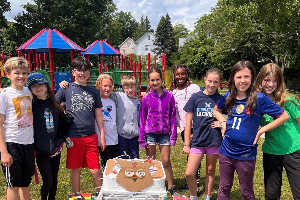 The class of fifth graders from Commodore MacDonough STEM Academy in Middletown, Connecticut who excitedly built with UConn experts a "Corsi-Rosenthal" air purifier device to be tested by EPA scientists. It is decorated with rainbows and their school’s owl mascot.