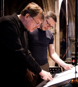 Composer and UConn music composition professor Kenneth Fuchs, left, looks over the musical score for the album "Cloud Slant" with Sinfonia of London conductor John Wilson. 