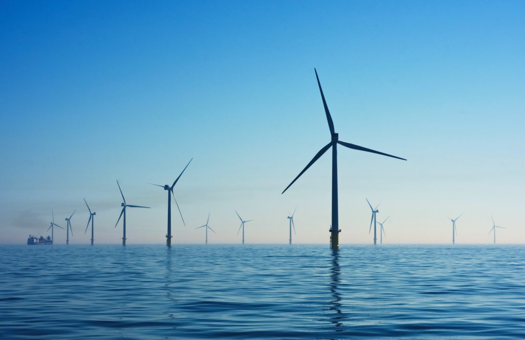 A series of wind turbines in the ocean.