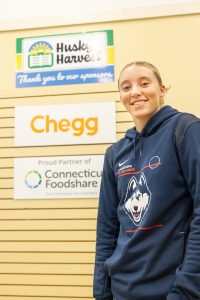 UConn women's basketball player Paige Bueckers poses for a photo in the Husky Harvest food pantry in Storrs during a press conference announcing hers and partner Chegg Inc.'s support for Husky Harvest