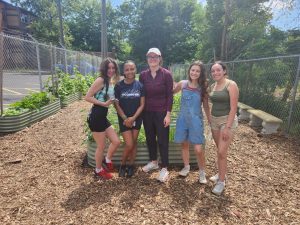 Members of the HealthWerx team garden at the Chrysalis Center’s Social Innovation Hub on July 7, 2023, in Hartford. From Left: Genesis Rosario '24 (CAHNR), Jewel Booker '25 (CLAS), Zoey England '22 (CLAS), Sophia Manos '24 (CLAS), and Brenda Lituma Solis '23 (CAHNR) '25 MS.