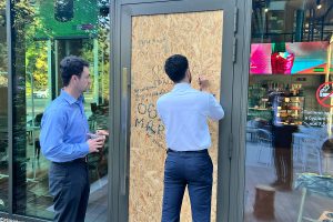 Goggins and Mallem, during the pair's second trip to Ukraine in August, visit the boarded up coffee shop in Lviv that reopened for business just days after it was damaged by Russian attacks on the city.