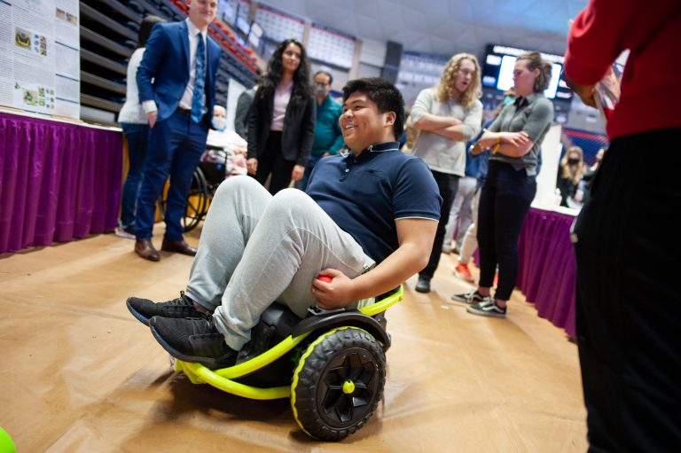 Young man uses a student-designed wheelchair.