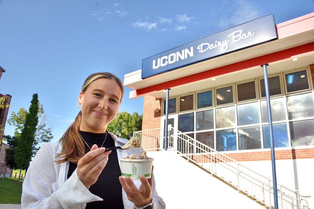 Female student holding ice cream outside of Dairy Bar