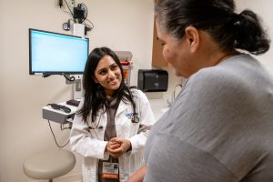 physician interacting with patient in exam room