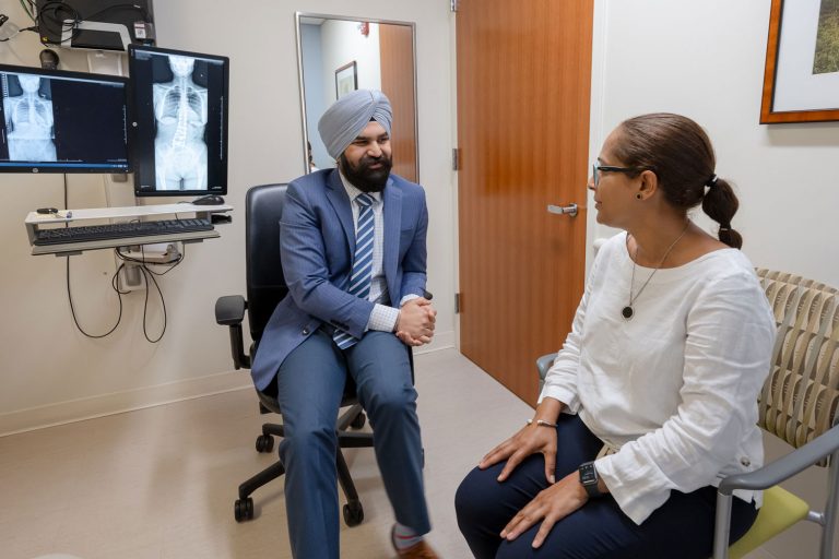 Dr. Hardeep Singh with patient in exam room