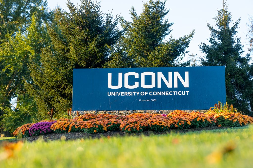 The University of Connecticut sign decorated with fall foliage
