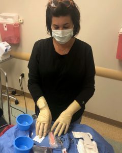 Medical assistant preparing surgical instruments