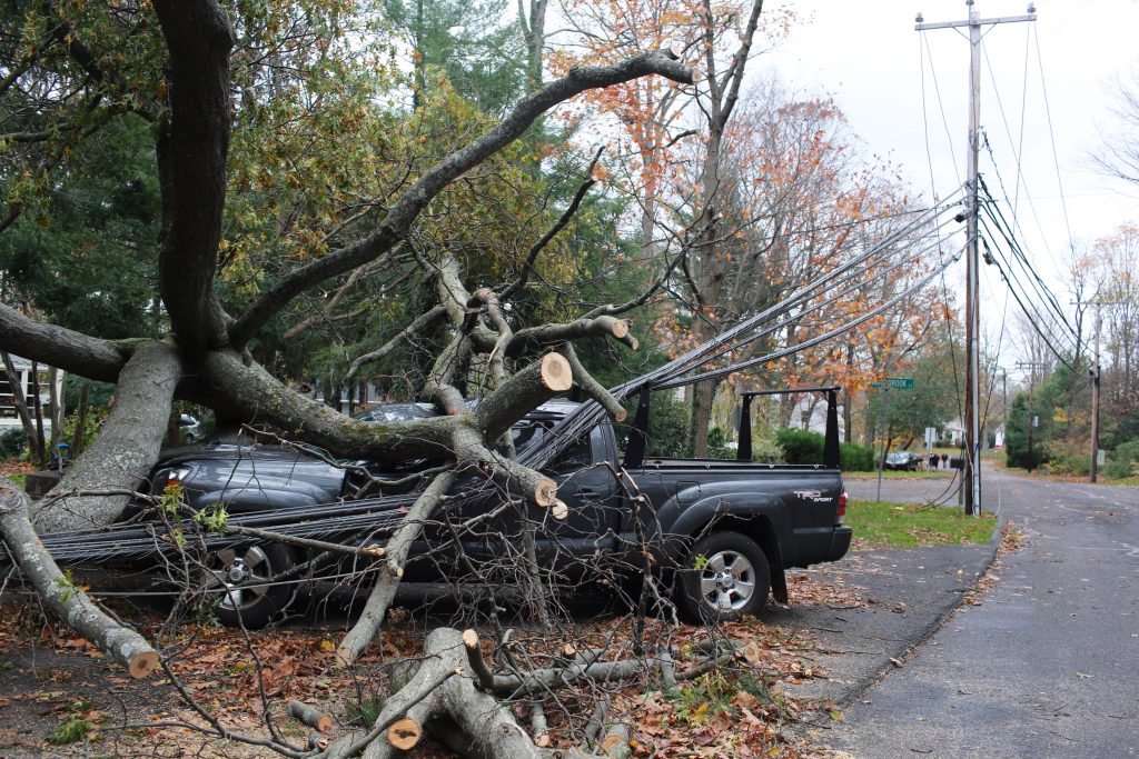 A fallen tree on a vehicle which brought down power lines on Comstock Hill Avenue in Norwalk, Connecticut during Hurricane Sandy on October 30, 2012.