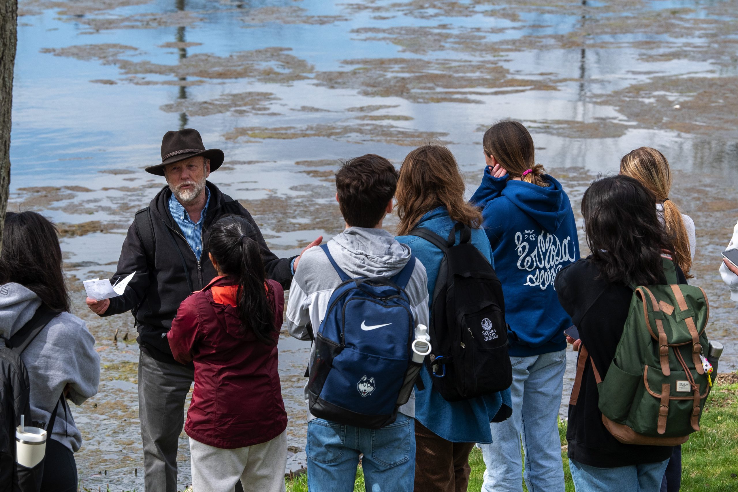 Students at Swan lake during an outdoor class by Professor Robert Thorson.