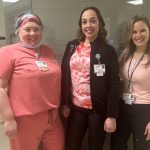 Group portrait of staff wearing pink