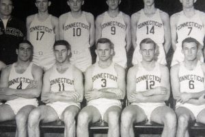 A yearbook photo shows the 1942 UConn men's basketball team, including John E. Winzler (12), whose UConn athletic letter sweater was accepted into the Husky Heritage Sports Museum in the Alumni Center
