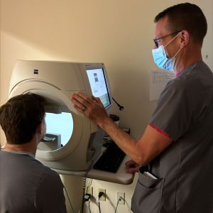 Ophthalmology tech demonstrating test