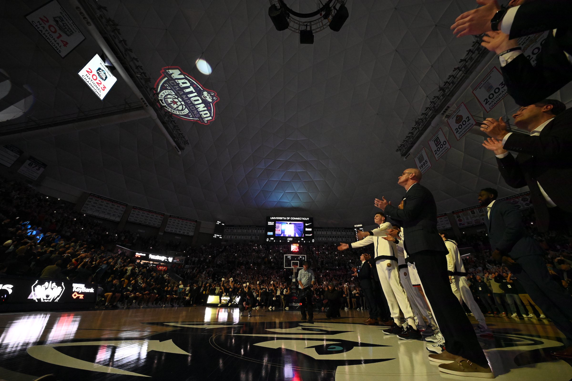 The 2023 NCAA championship banner was unveiled before a record crowd for the men's home opener at Gampel Pavilion.