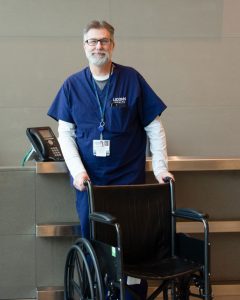 Daniel Lambert pushing an empty wheelchair