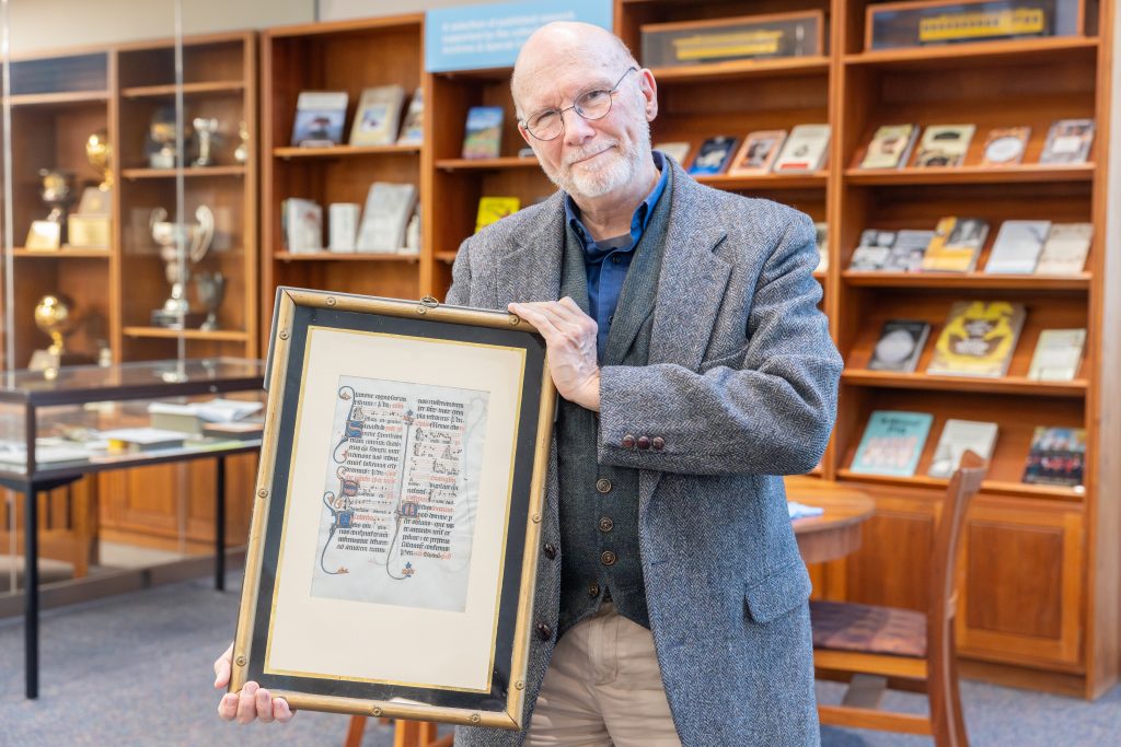 Thomas Long, professor-in-residence emeritus and director of the Nursing Learning Community, holds a leaf from the Beauvais Missal, which he recently donated to the Archives and Special Collections at the Thomas J. Dodd Research Center, in the Dodd Center for Human Rights