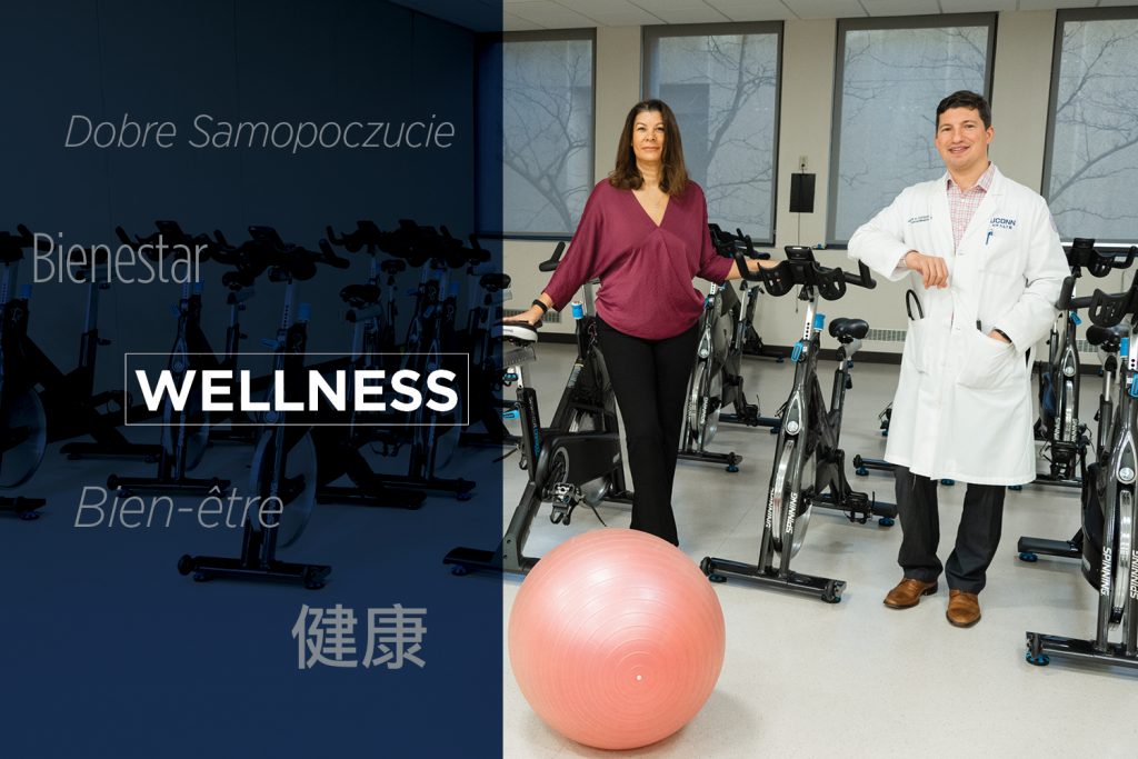 portrait of woman and man in workout room with the words "Wellness" in English and four other languages superimposed