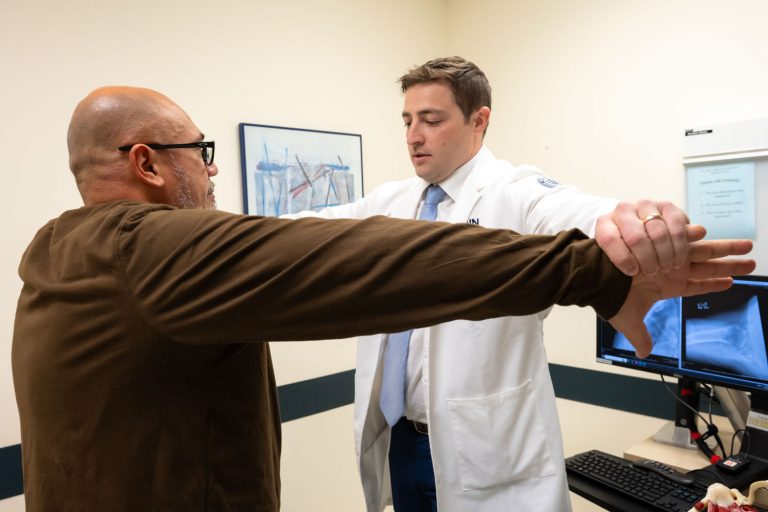 Physician interacting with patient in exam room
