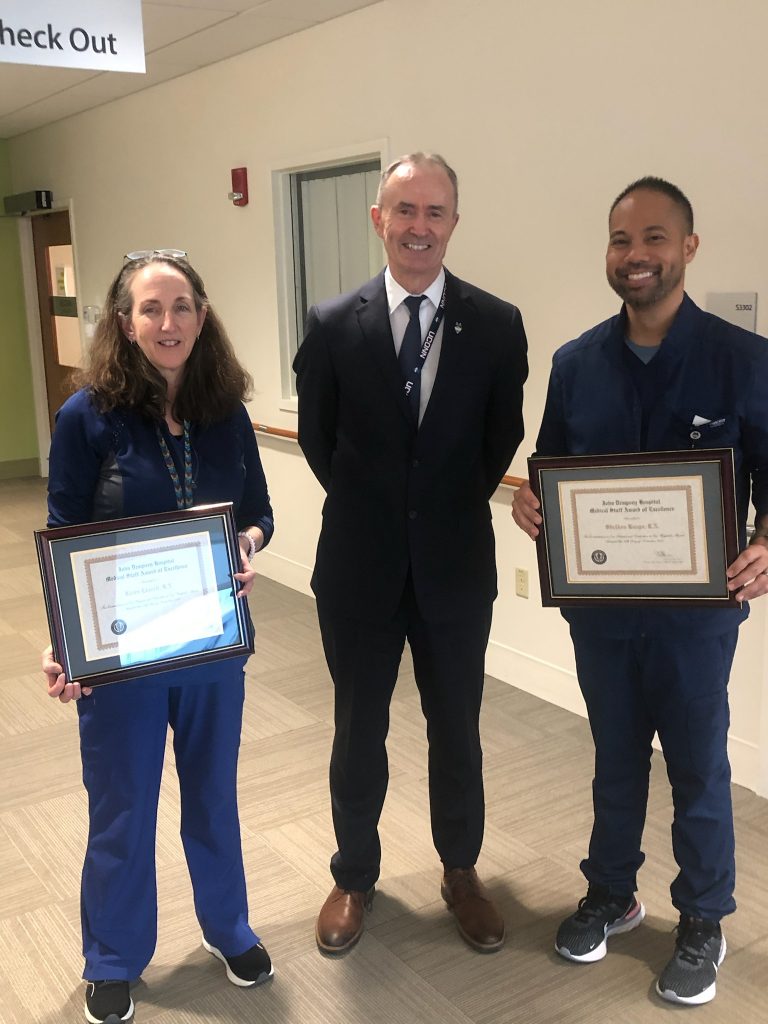 Karen Leavitt, R.N. and Sheldon Rasgo, R.N. (Urology Clinic) accepting their awards from Dr. Coll. 