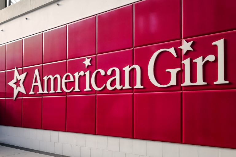 American Girl company logo on large burgundy tiles