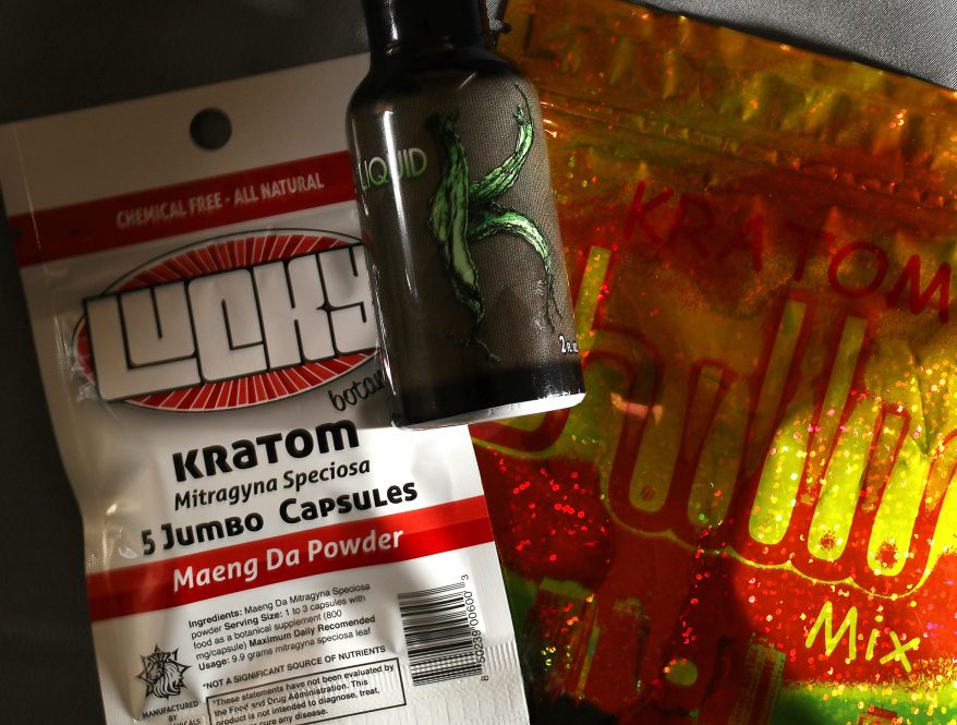 A photo illustration showing a packet of supplements containing the substance kratom, along with a bottle of pills that contain it.