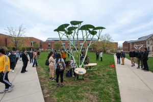 People gather around the solar-powered STEAM Tree at UConn.