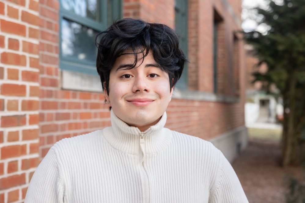 Kevin Quezada '24 poses for a photo outside Young Building