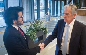 UConn student Felix Velazquez '24 (CLAS) shakes hands with U.S. Federal Reserve Chairman Jerome H. Powell