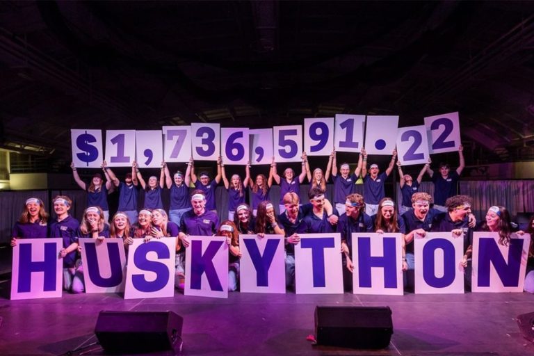HuskyTHON students holding up the total amount they raised during this years' HuskyTHON