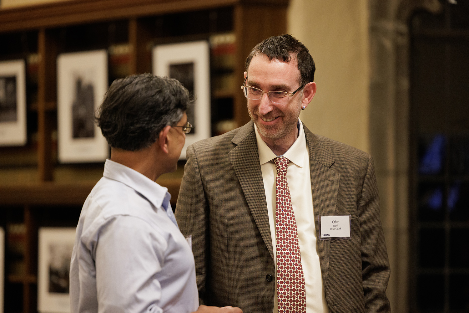 Interim Dean Ofer Harel speaks with an attendee of the first UConn Impact series event.
