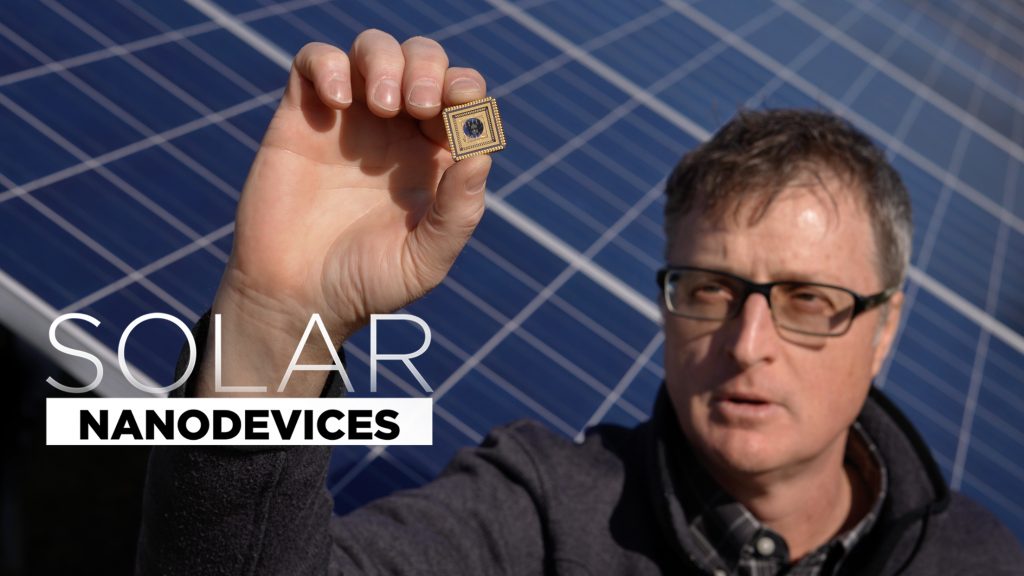 UConn researcher Brian Willis holding up nano technology in front of solar panels with the video title "Solar Nanodevice" overlaid