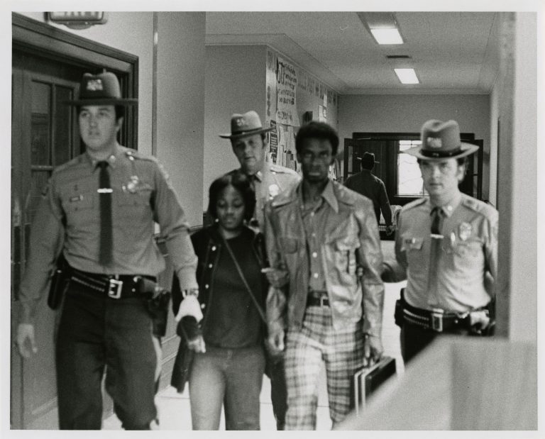 In an archival photo, Black students are taken from the old Wilbur Cross Library by Connecticut State Police.