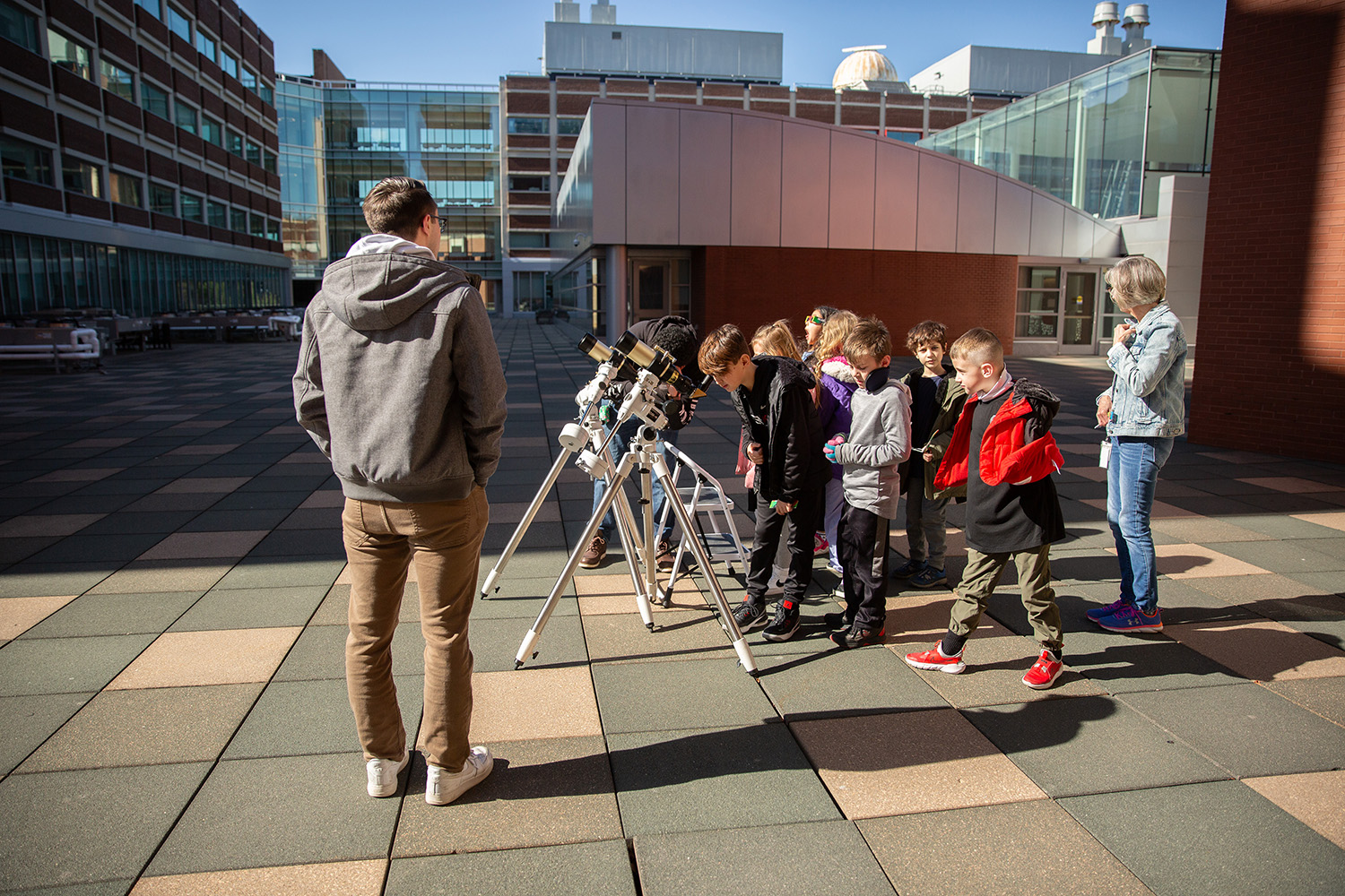 Students look at a telescope during a trip to UConn's main campus in Storrs.