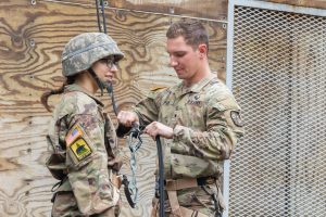 UConn Army ROTC cadet Christopher Paier (left) helps a fellow cadet from the University of Maine on the rappel tower.