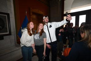Alex Karaban poses for a selfie with fans at the State Capitol on Saturday, April 13.