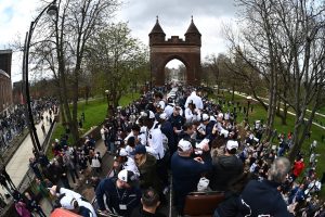 The double-decker bus with the UConn men's team moves through the Soldiers and Sailors Memorial Arch at Bushnell Park in Hartford.