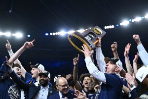 Dan Hurley hoists the national championship trophy after winning back-to-back national titles. (Courtesy of the NCAA)