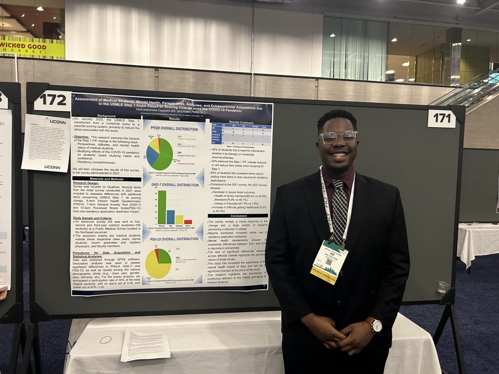 UConn School of Medicine student Ire Opayemi presenting his winning research poster at the American College of Physicians national Internal Medicine Meeting.