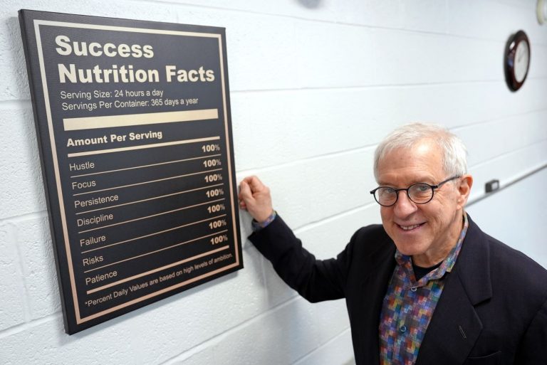Jerold “Jerry” Mande ’78 (CAHNR) next to a Success Nutrition Facts label based on the FDA Nutrition Facts label Mande helped design. (Jason Sheldon/UConn Photo)