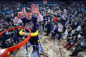 Dan Hurley stands at the hoop after winning the NCAA national championship.