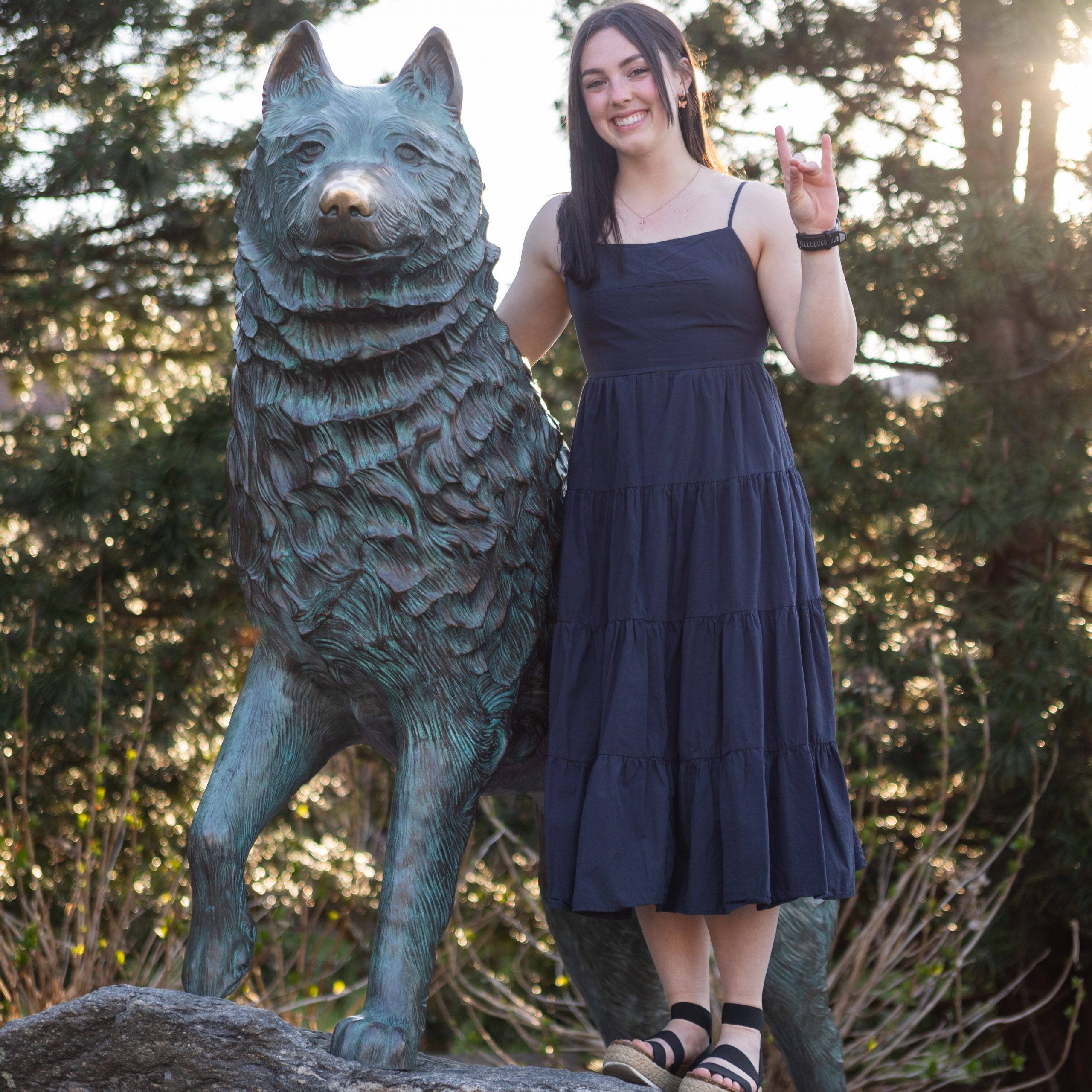 Sarah Meade '24 (CAHNR) with the Jonathan the Husky statue. (James Shiang/UConn Photo)
